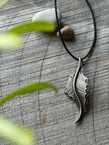 Hand-engraved sterling silver heron feather on balck cord.