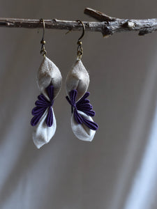 white and purple earrings