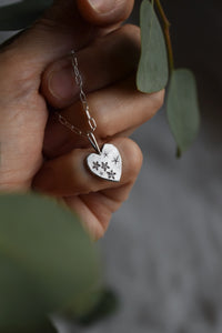 hand engraved and handcrafted silver heart pendant. 