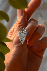 silver heart pendant with a clear cz